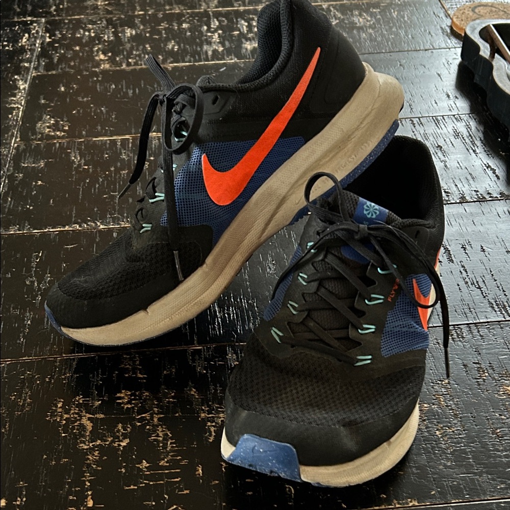 Nike Black and Blue Running Shoes with Vibrant Orange Logo